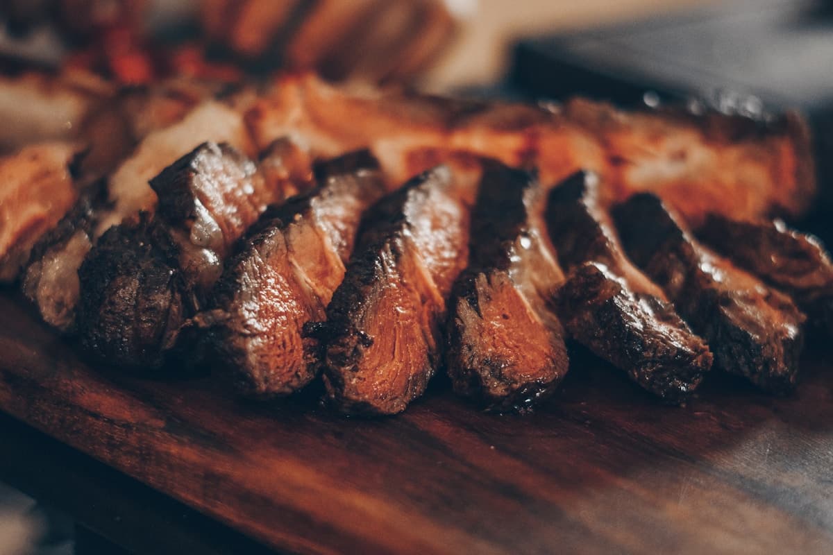 Perfectly seared dry-aged steak with a golden crust on a white plate