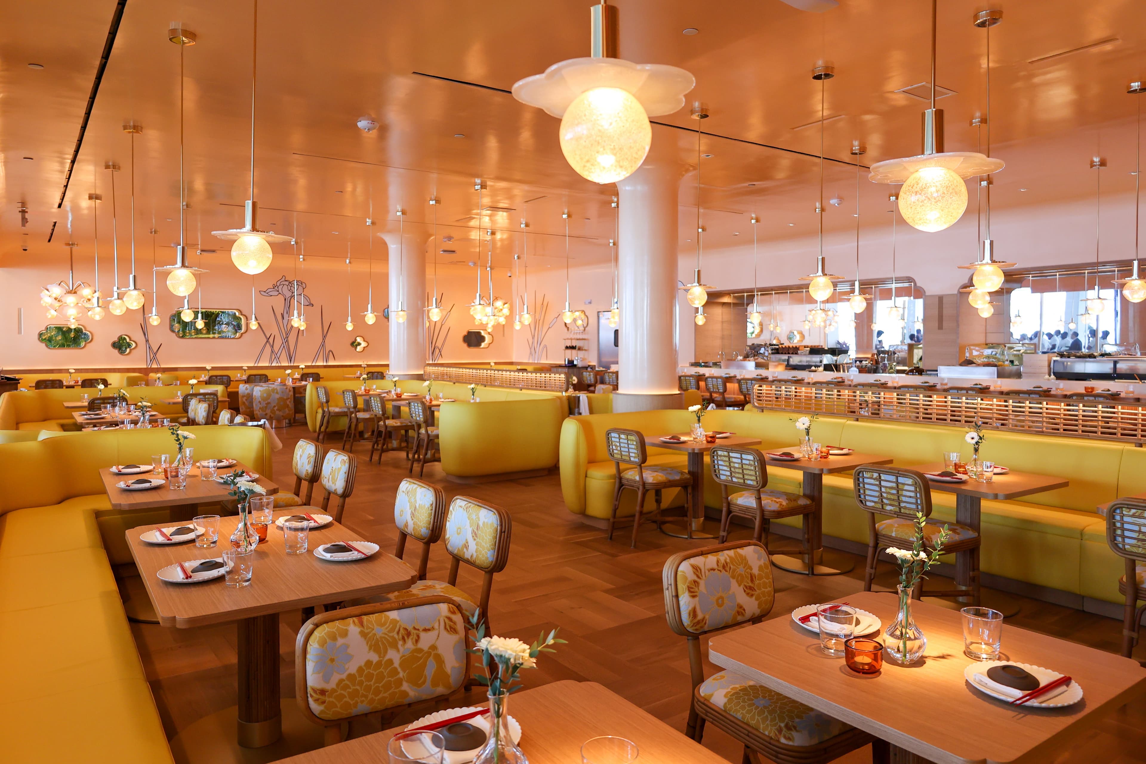 An intimate Japanese dining room and sushi counter with warm lighting in Miami