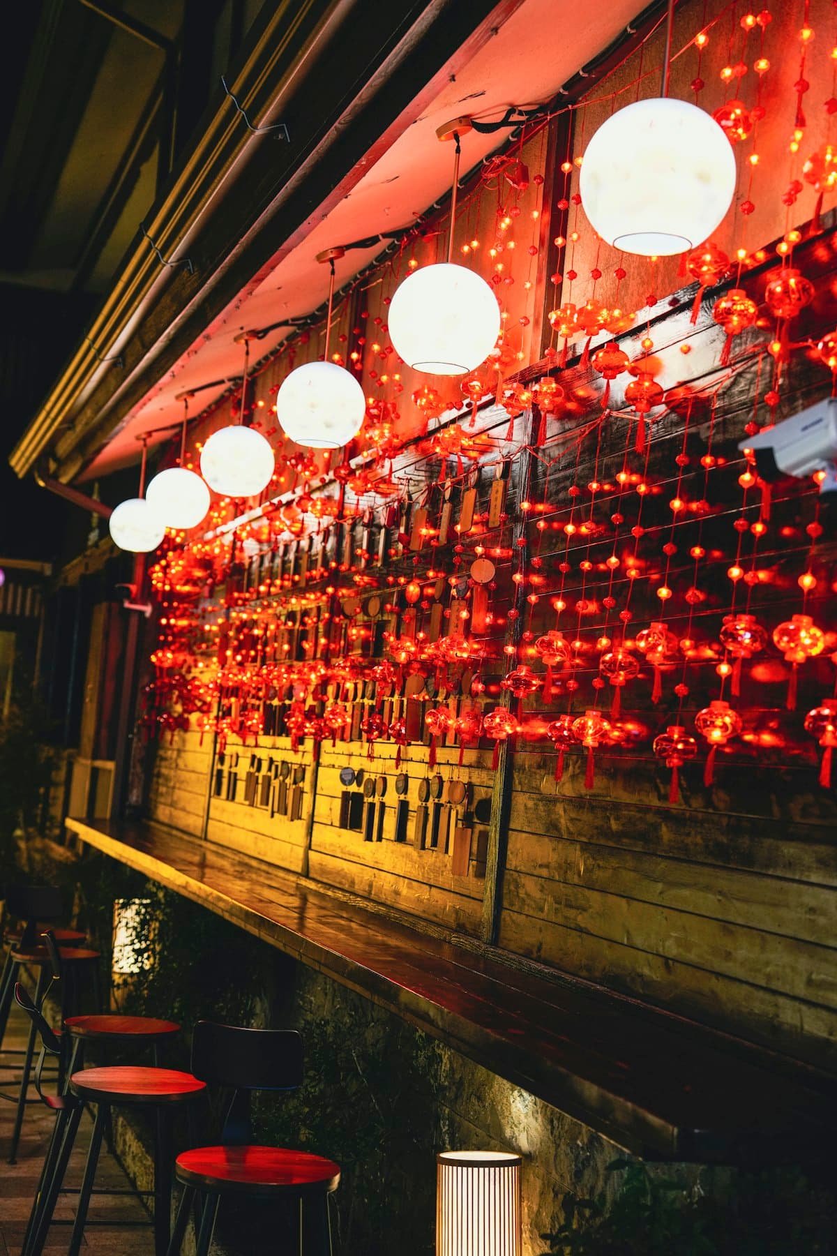 A moody restaurant interior with red lighting and a polished dinner-room atmosphere