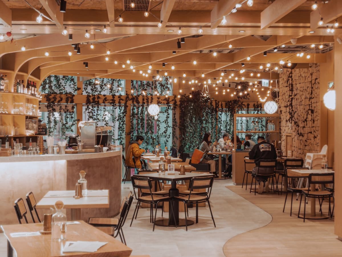Warm open-kitchen restaurant interior with glowing lights and intimate dinner seating