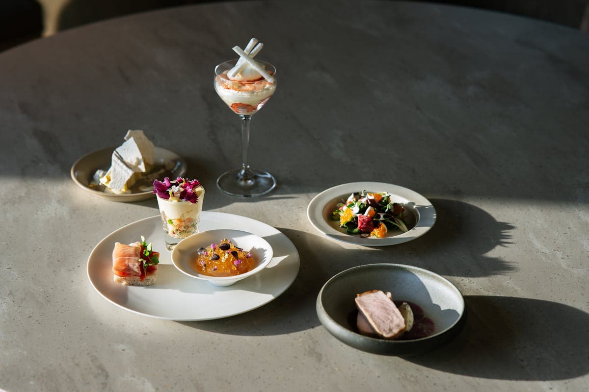 Gourmet dishes elegantly plated on a fine dining table setting