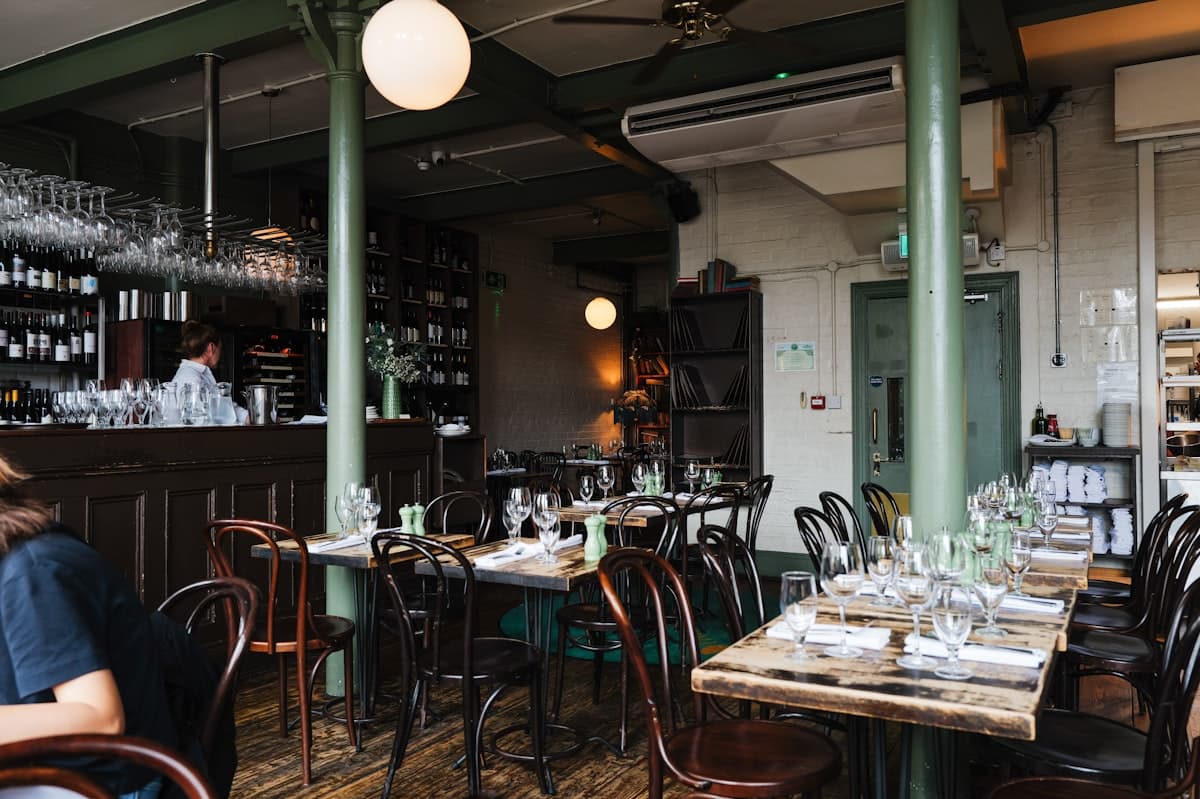 Elegant upscale restaurant interior with warm lighting and refined bar seating