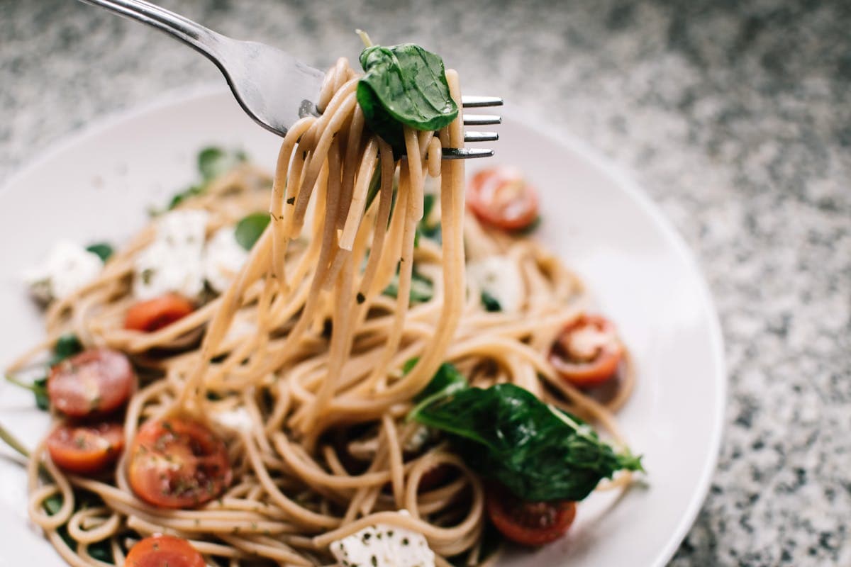 Beautifully plated pasta dish with garnish at a restaurant