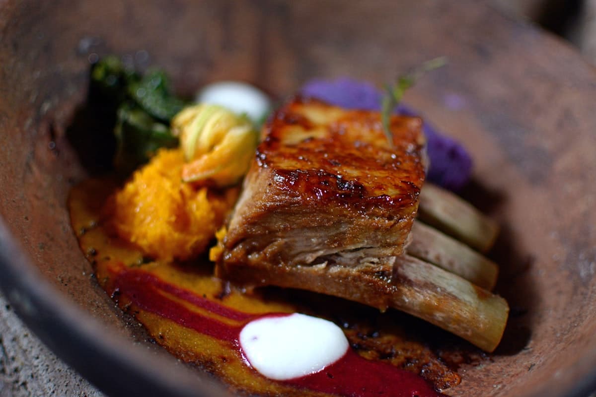 Beautifully plated modern fine dining course with vibrant colors