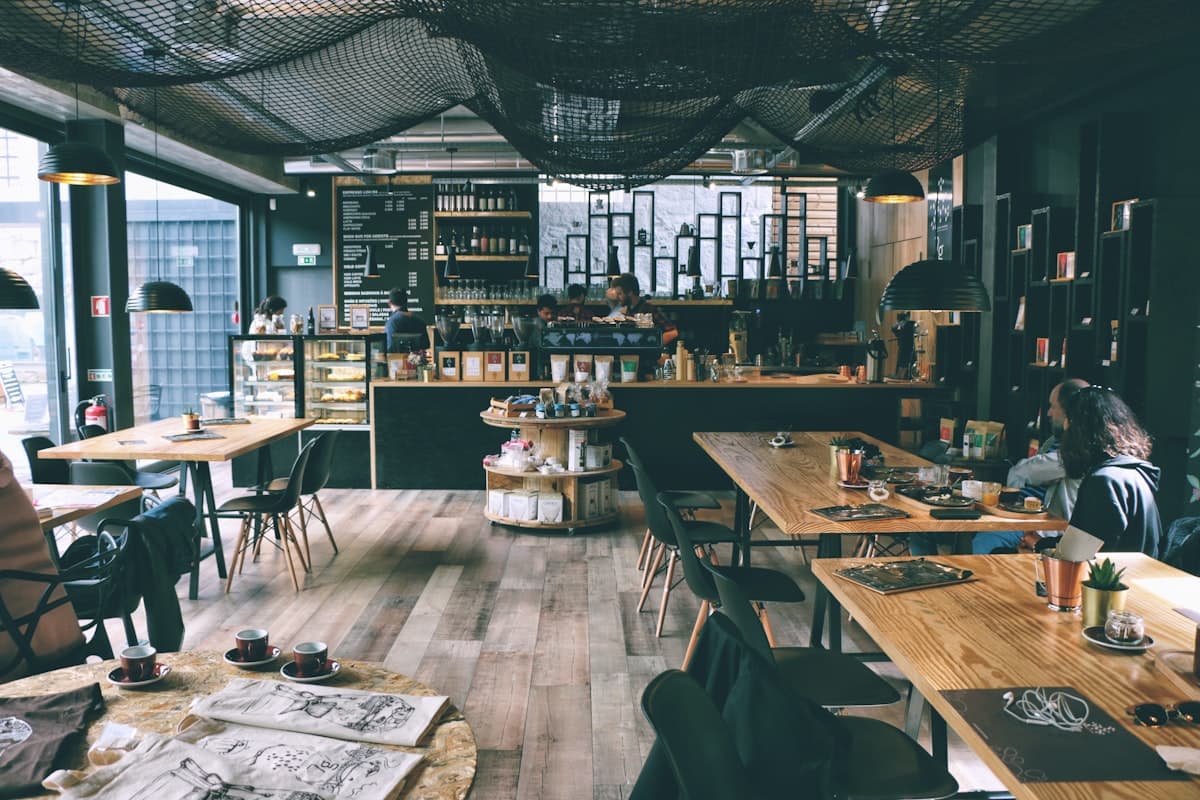 Warm, dimly lit interior of a cozy neighborhood restaurant with exposed brick walls