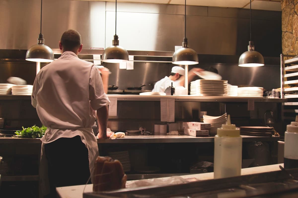 Warm, dimly lit Los Angeles restaurant interior with elegant table settings