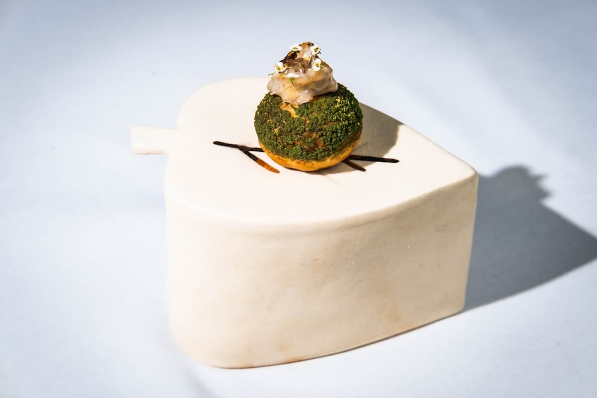 Elegant fine dining tasting menu course beautifully plated